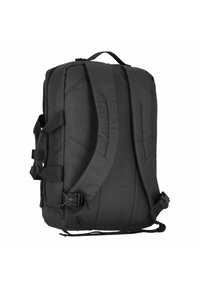 Sac à dos en tissu noir avec un dos rembourré et des bretelles réglables. Comprend des boucles latérales et une poignée supérieure pour un transport facile.