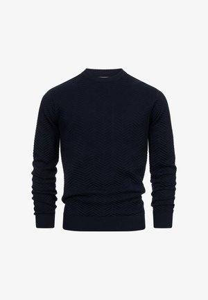 Laivansinisessä neulepaidassa on teksturoitu herringbone-kuvio, pyöreä pääntie sekä ribbireunat hihansuissa ja helman alla, ja se on valmistettu pehmeästä neulemateriaalista.