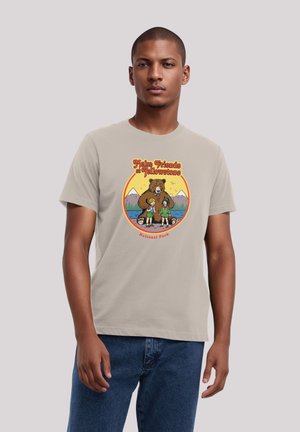Beige cotton t-shirt featuring multicolored graphic of a bear and children, with text "Make Friends at Yellowstone" and mountain backdrop.