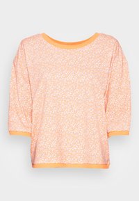 Short-sleeve, loose-fitting top in light orange with a white speckled pattern. Features an orange ribbed neckline and cuffs. Soft fabric texture.