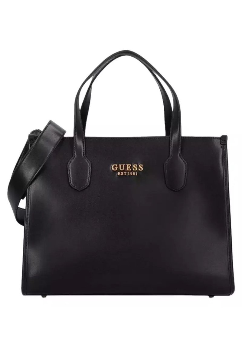 Sac à main Guess en cuir noir avec deux poignées supérieures, une bandoulière ajustable et un logo gravé en or "GUESS EST 1981" à l'avant.