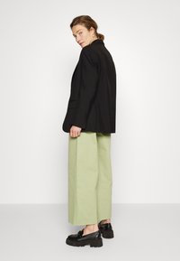 ALIGNE CONNIE WIDE - Calças de ganga à boca de sino - cucumber