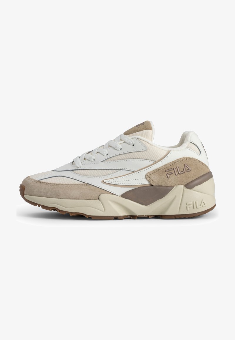 Baskets basses beige et blanches FILA avec accents en daim, fermeture à lacets et semelle épaisse et rembourrée vue de l’extérieur.