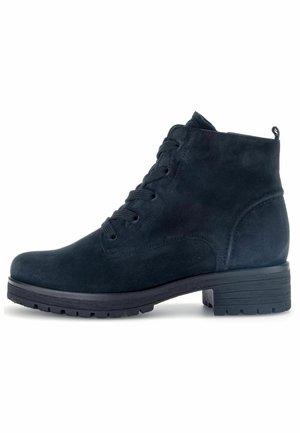 Black suede ankle boot with a round toe, lace-up front, and textured rubber sole; features a small pull tab at the back.