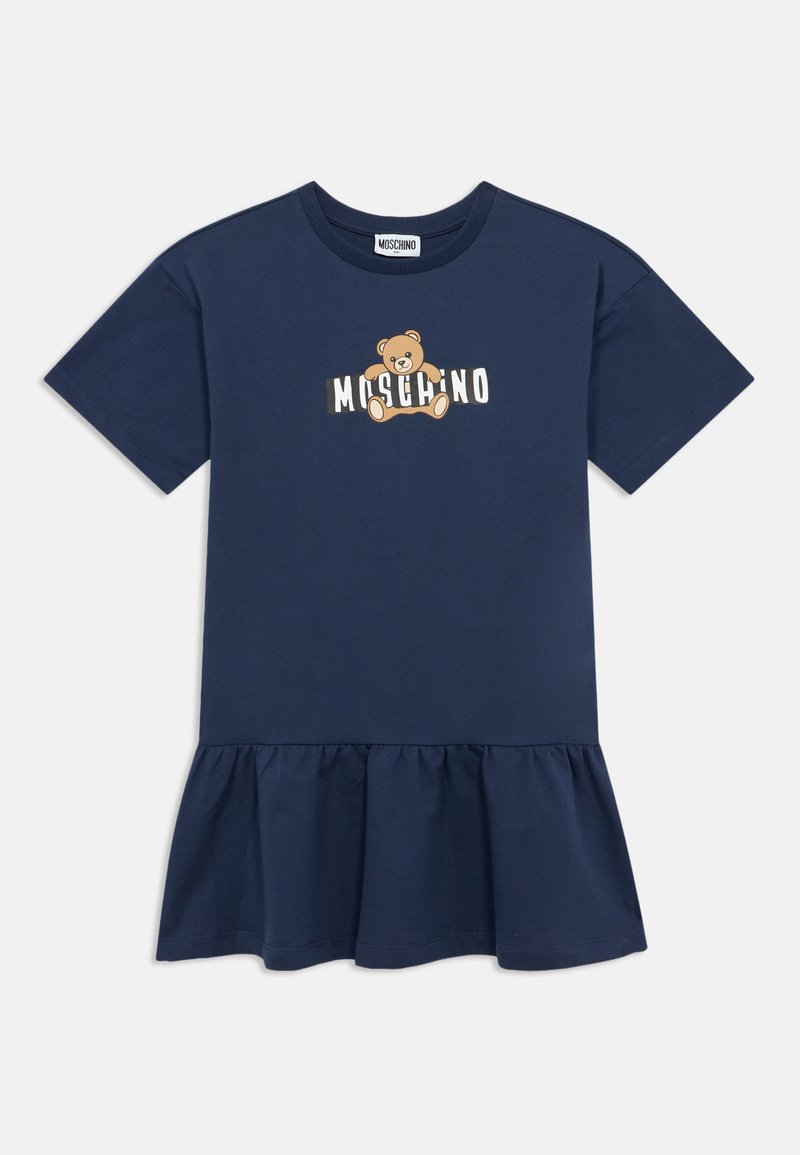 Μπλε ναυτικό βαμβακερό φόρεμα με κοντά μανίκια, φραμπαλά στο τελείωμα και κεντρικό σχέδιο με αρκούδα και το κείμενο "MOSCHINO" από κάτω.