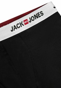 Black boxer briefs with a white and burgundy elastic waistband featuring "JACK & JONES" logo, smooth texture, and fitted design.