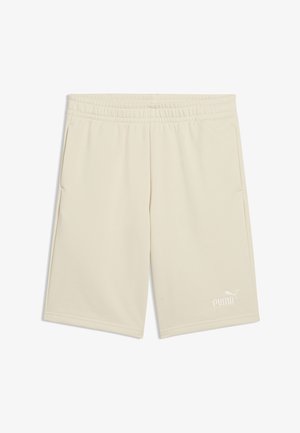 Shorts de sport beiges à taille élastique avec poches latérales et logo Puma blanc sur la partie inférieure de la jambe droite.