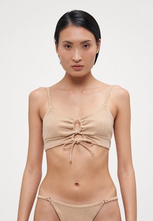 Striped bikini top in beige and white with gathered fabric, a keyhole detail at the center, and adjustable straps. Simple matching bottom.
