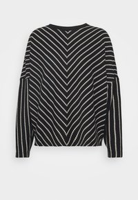 Black and cream striped sweater featuring a chevron pattern, wide sleeves, and a relaxed fit. Material appears soft with a textured finish.