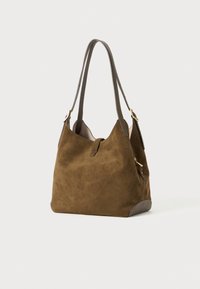 Brown suede hobo bag with two long leather straps, a soft texture, and a gold-tone zipper accent on the side. Features a slouchy shape.
