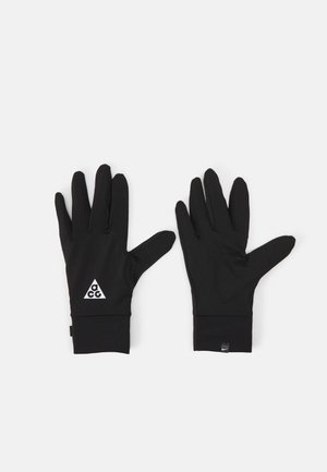 Black gloves made of a smooth, stretchy material. They feature a triangular white logo and snug cuffs for comfort and ease of wear.