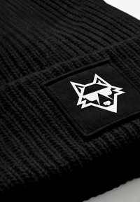 Black knit beanie with a sewn black patch featuring a white stylized fox head wearing sunglasses logo.