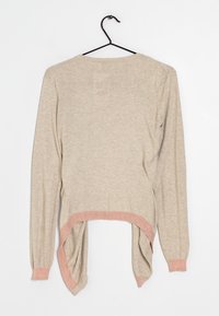 Top beige a maniche lunghe con orlo curvo, caratterizzato da un bordo glitterato rosa nella parte inferiore e nei polsi. Tessuto morbido con vestibilità comoda.