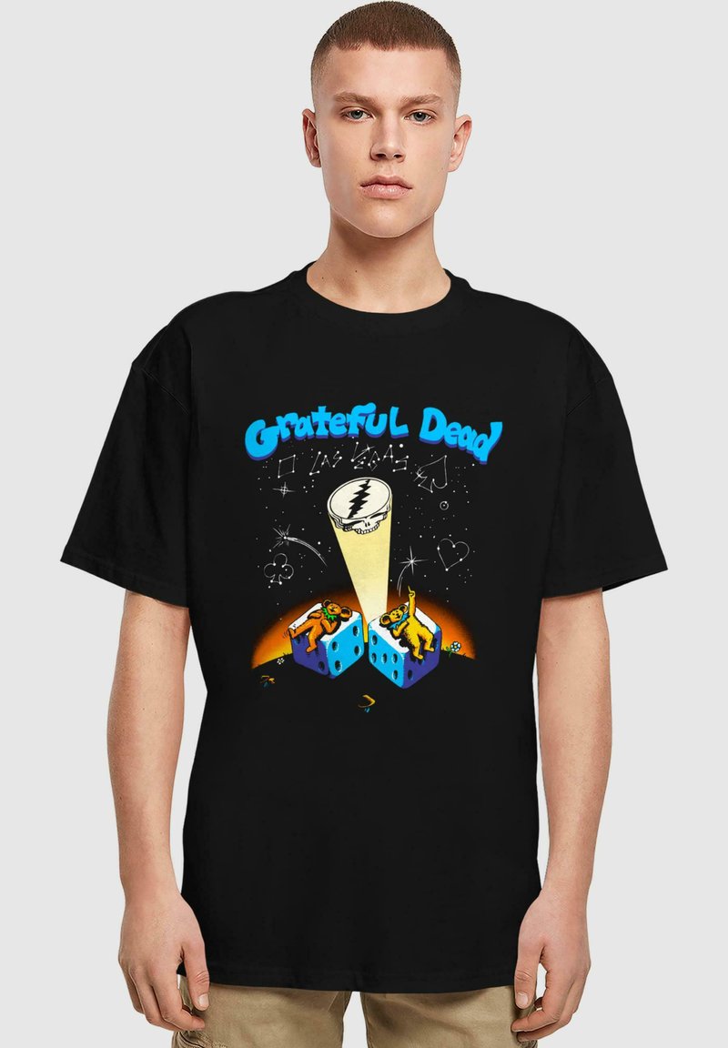 Svart bomullstrøye med et flerfarget grafikk av to bjørner på blå terninger, med "Grateful Dead"-tekst og et lyn-design.