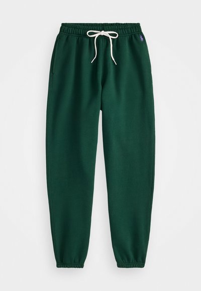 Green sweatpants made of cotton blend, featuring an elastic waistband with white drawstring, side pockets, and tapered cuffs.