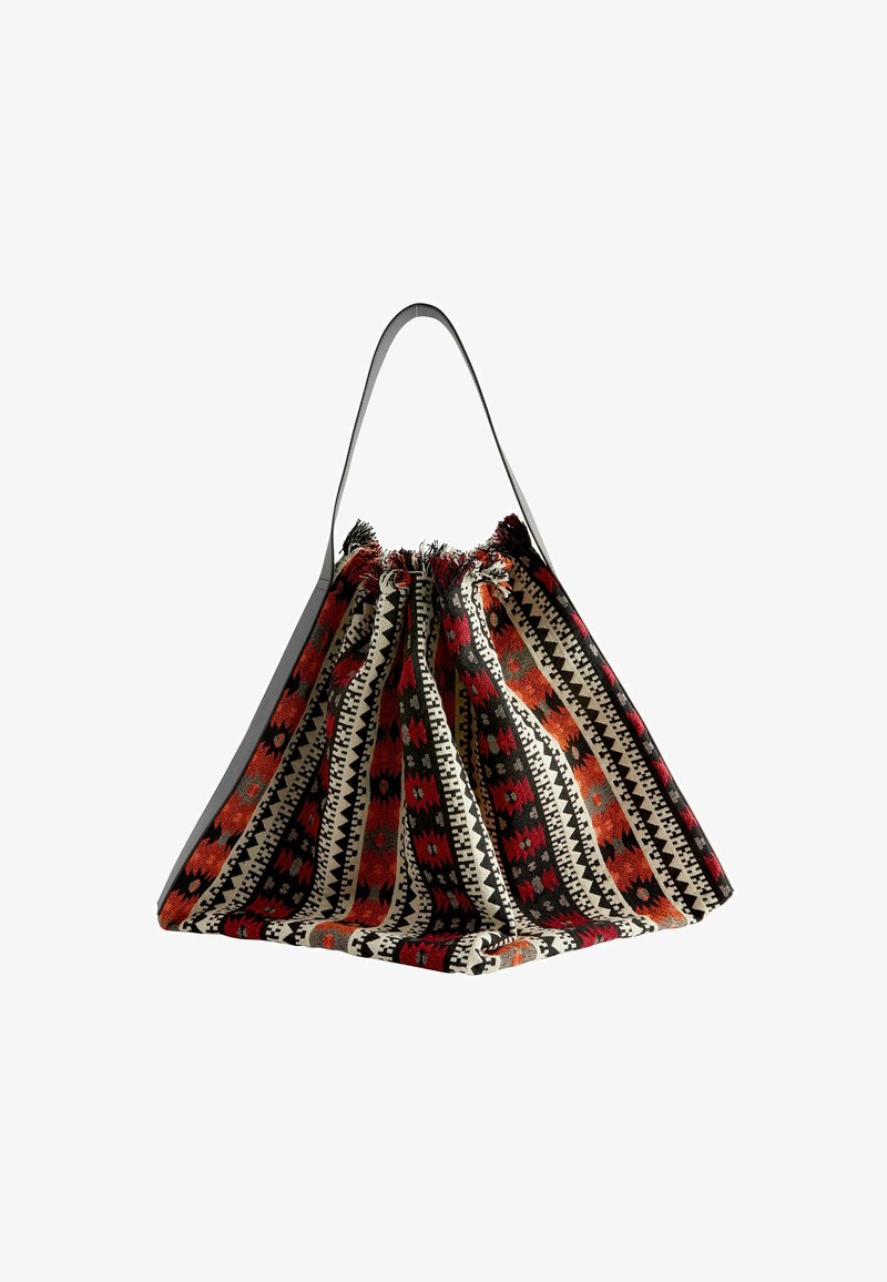 Textile bag with a drawstring top, featuring a geometric pattern in red, orange, black, and cream, and a gray strap. Soft, textured fabric.