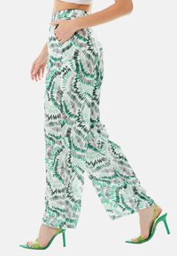 Lightweight, patterned wide-leg pants in green and black on a white background, featuring side pockets and a high waistband.
