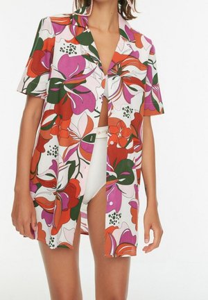 Kurzärmliges Hemd mit einem Blumenmuster in Rot, Lila, Grün und Weiß. Leichter Stoff mit lockerem Schnitt und Kragen.