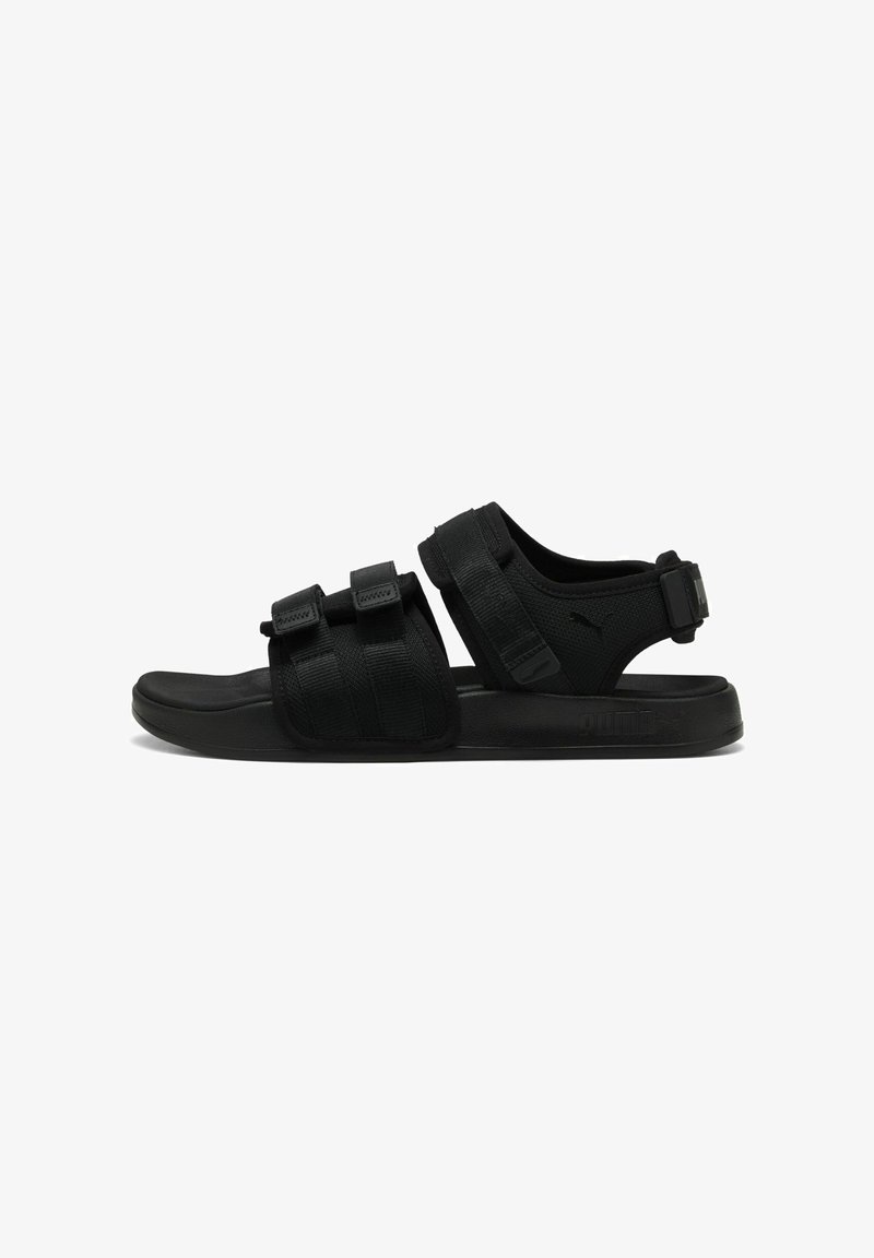 Black sports sandals with adjustable straps, textured fabric, cushioned footbed, and a fitted sole. Features logo accents.