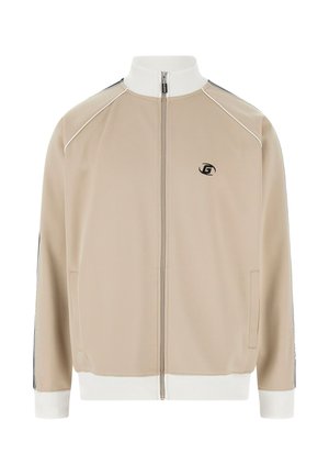 Beige track jacket with a white high collar, front zipper, side pockets, and black accents on sleeves. Features a small logo on the chest.