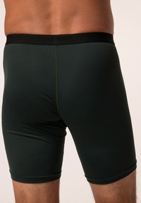 Tmavě zelené elastické boxerky z jemné látky s černým elastickým pasem, které mají hladký povrch a přiléhavý střih pro komfort.