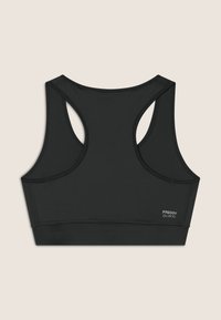Bra sportivo nero con design a dorso scoperto, realizzato in tessuto liscio ed elasticizzato. Presenta cuciture piatte e un piccolo logo sulla parte anteriore.