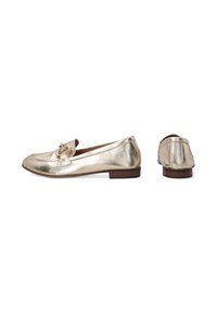 Metallic gold loafers with a smooth texture, designed with a decorative hardware accent on the front, and a low brown stacked heel.