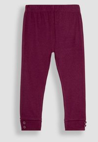 Burgundi színű bordázott leggings, elasztikus derékkal és gombdíszítéssel az alsó részen, puha tapintással és feszes sziluettel.