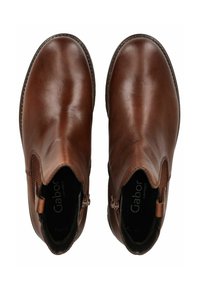 Bottines en cuir marron avec une finition lisse, des panneaux latéraux élastiques et un bout rond. Présente une fermeture éclair sur un côté.