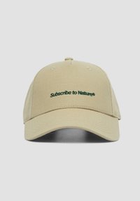 Beige fabric cap with a structured design, featuring an embroidered green "Subscribe to Nature®" on the front and a curved brim.