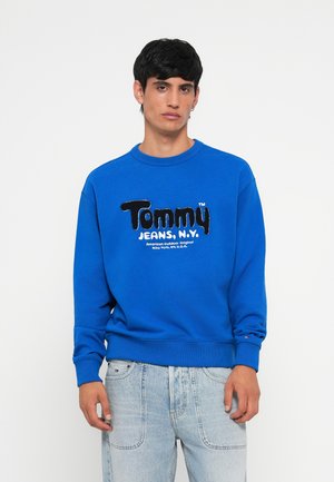 Blauwe sweatshirt van een katoenmengsel, met een gestructureerd "Tommy Jeans" logo op de borst. Rib gebreide halslijn en manchetten, ontspannen pasvorm.