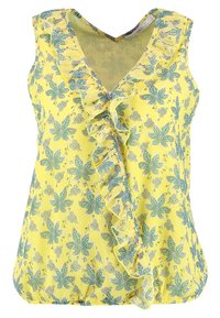 Gul blus med blomtryck, V-ringning och volangdetaljer fram. Har gröna bladmönster och en lätt tygtextur.