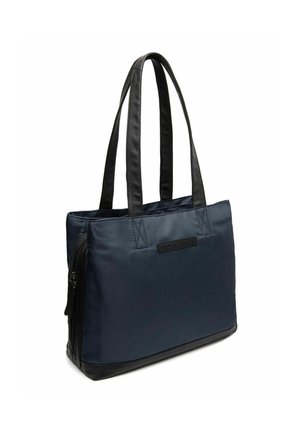 Sac fourre-tout en tissu bleu marine avec des accents en simili cuir noir, poche latérale zippée et doubles poignées douces pour un transport facile.