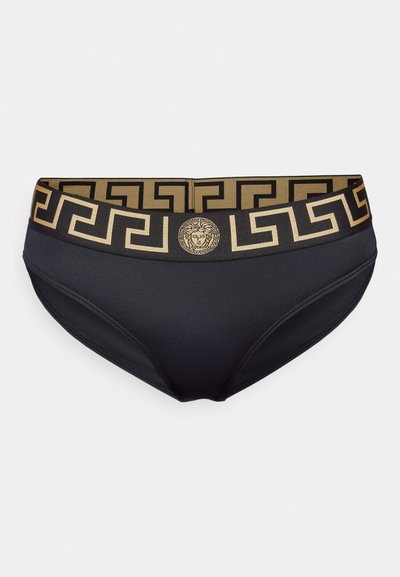 Black bikini panties with a gold patterned waistband featuring a Greek key design and a central Medusa emblem. Smooth, stretchy fabric.
