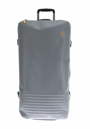 Sac de voyage étanche gris avec une forme rectangulaire, des rainures texturées au fond et une poignée rétractable. Détail d'accent en zip jaune.