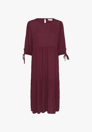 Bordo mekko, joka on valmistettu kevyestä kankaasta. Siinä on kolme neljännesosakynttä, solmuiset yksityiskohdat, avara selkä ja kerroksellinen hameen muoto.