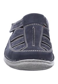 Navy blue leather slip-on shoe with cutouts, white stitching, a padded tongue, and a textured rubber sole. No laces; adjustable strap.