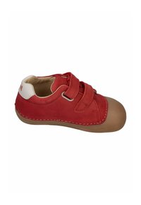 Red leather sneaker with two hook-and-loop straps, a tan rubber sole, and white heel accent. Features textured upper and decorative stitching.