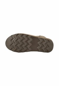 Suela de goma marrón con textura en zigzag y patrón circular. Diseñada para ofrecer tracción, cuenta con un tacón plano y borde reforzado.