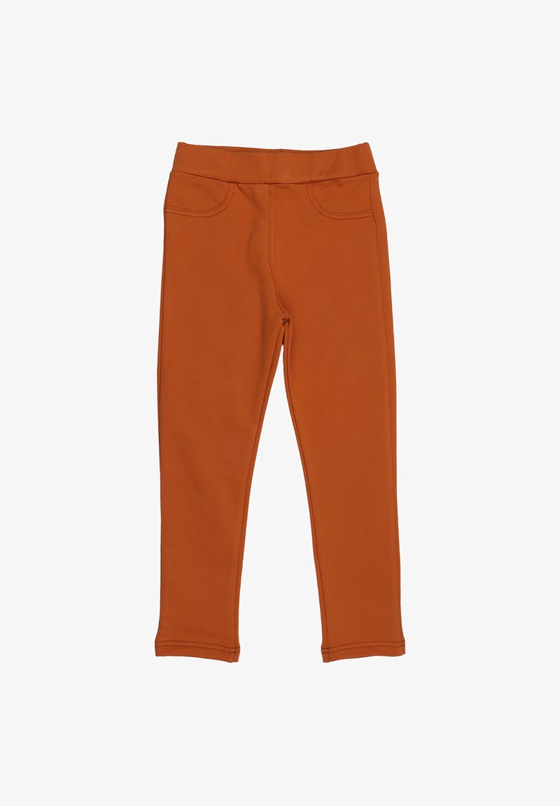 Orange Leggings aus weichem Stoff, mit enganliegendem Design, elastischem Bund und zwei Fronttaschen. Glatte Textur und einfache Nähte.