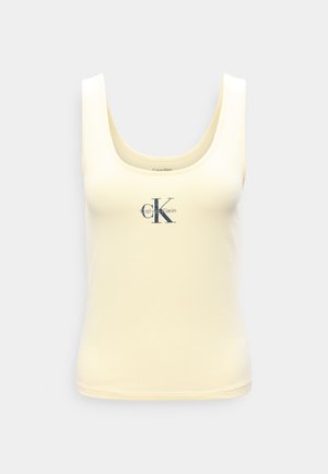 Αμάνικη μπλούζα σε κρεμ χρώμα με στρογγυλή λαιμόκοψη και μαύρο λογότυπο "CK Calvin Klein" στο κέντρο μπροστά.