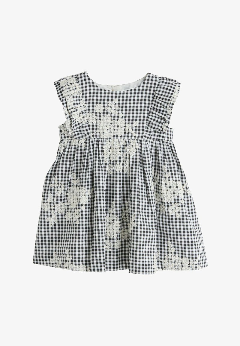 Robe en vichy noir et blanc avec manches à volants, ornée de broderies florales blanches et d'une taille froncée. Fabriquée en tissu léger.