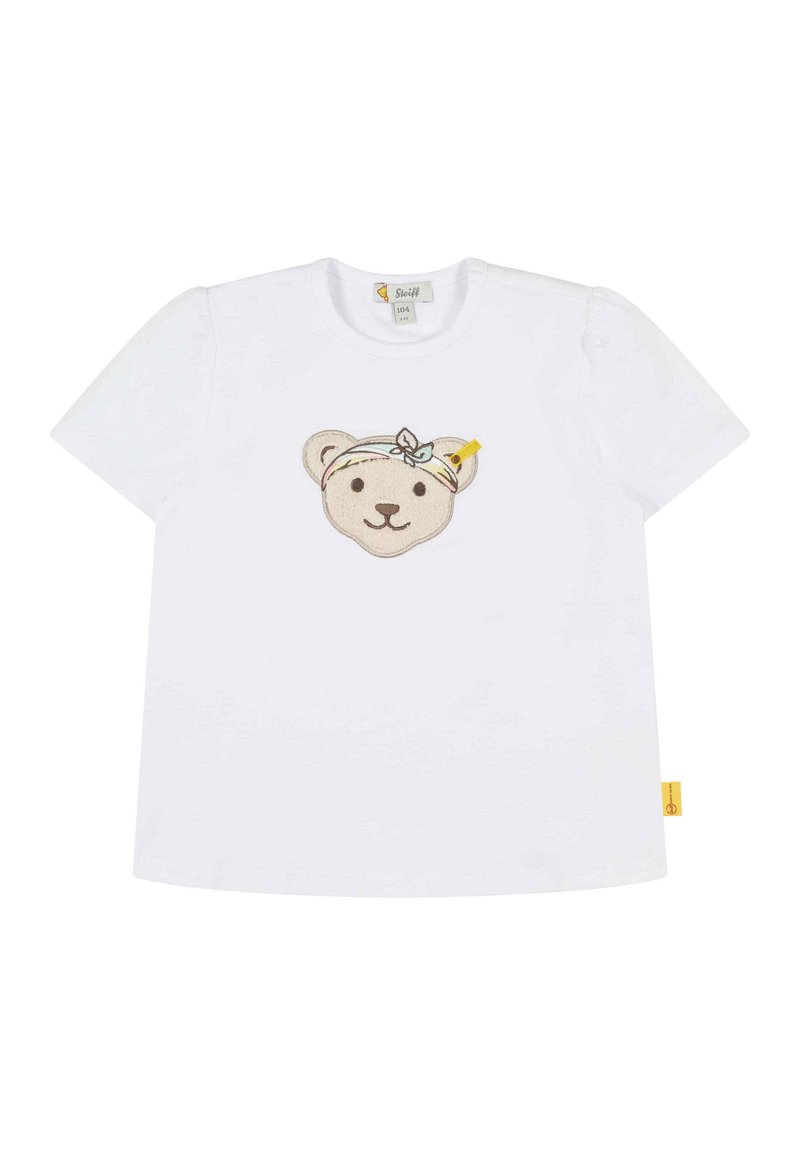 T-shirt bianco in cotone con maniche corte, caratterizzato da un volto di orso ricamato e texturizzato con una fascia per capelli e una piccola etichetta gialla.
