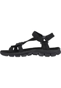 Black outdoor sandal featuring adjustable straps, a cushioned sole, and a textured rubber outsole with distinct traction patterns.