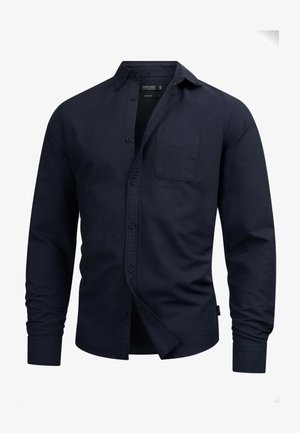 Camicia blu navy a maniche lunghe in cotone con colletto button-down, tasca sul petto e orlo dritto. Presenta chiusura frontale con bottoni.
