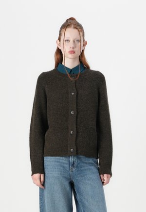 Dark green knitted cardigan with a round neckline and button closure. Features a textured finish and ribbed cuffs. Worn over a blue shirt.