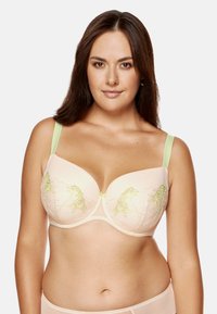 Jasno brzoskwiniowy biustonosz z zieloną haftowaną florą, z fiszbinami i szerokimi ramiączkami. Gładki materiał z małym zapięciem z przodu.