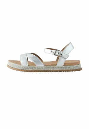 Hõbedane metallik avatud varbaga sandaal, millel on pahkluu pandlaga rihm ja sädelevate litritega kaetud kiviäärisega talla serv vähemalt pruunil platvormil.