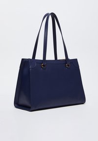 Borsa a spalla blu navy con texture in pelle liscia, due manici lunghi e dettagli in metallo color oro. Forma rettangolare con design strutturato.