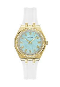 Gold octagonal watch with a light blue dial, Roman numerals, rhinestone accents, and a white silicone strap.